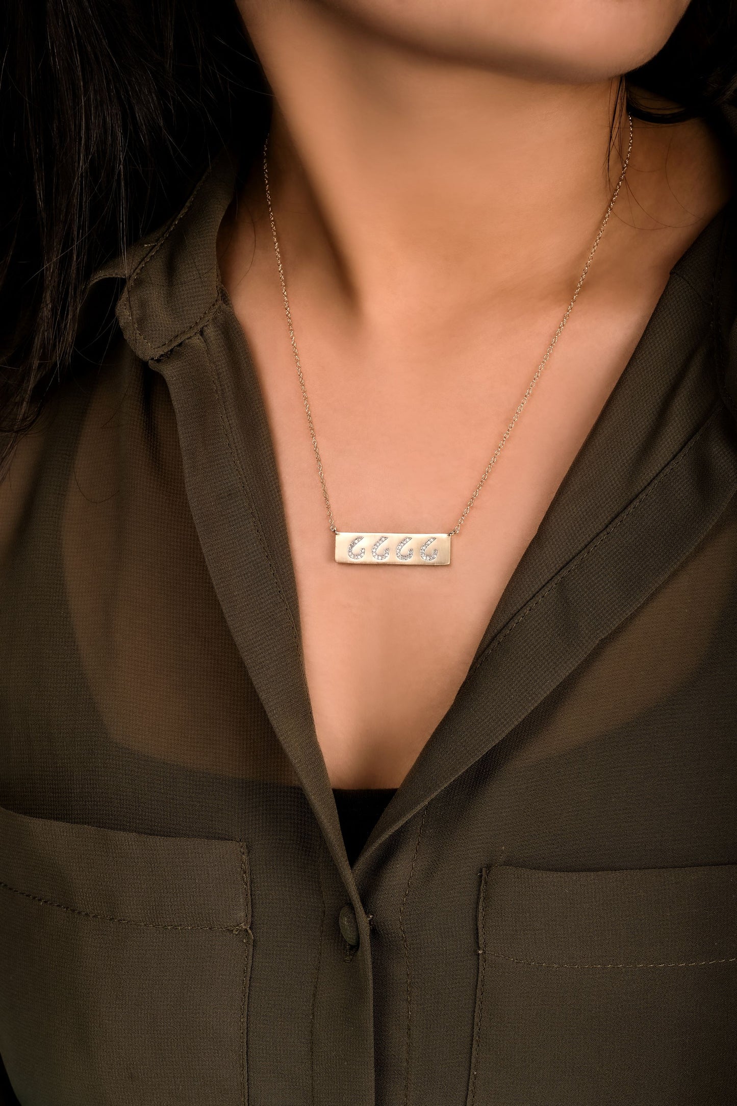 Model Image - A sleek diamond cattle brand bar necklace, featuring delicate diamond accents arranged in the shape of a personalized cattle brand symbol. A sophisticated tribute to Western heritage and individual style.
